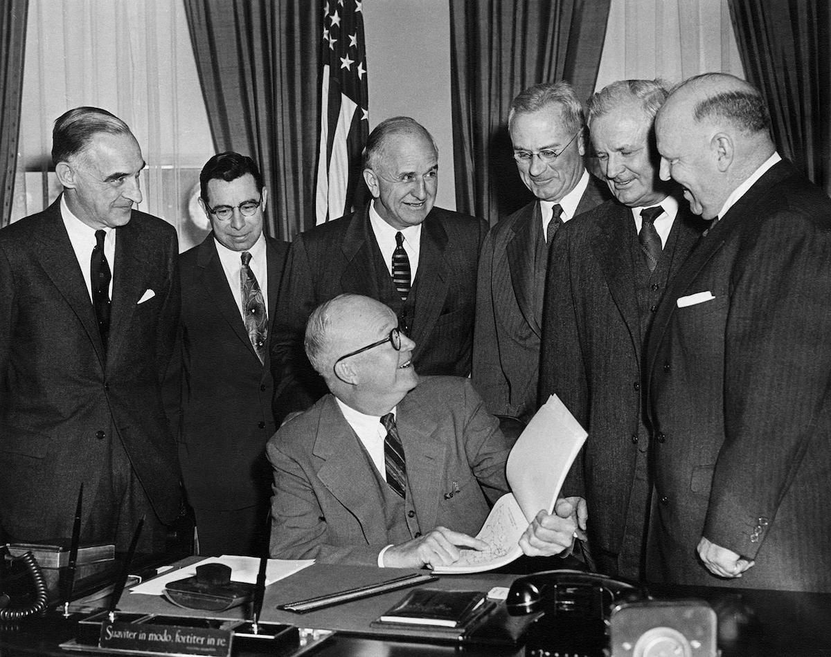 President Dwight D. Eisenhower receives a highway-financing report from his advisory committee, January 11, 1955.